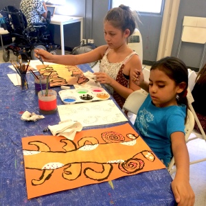 Tree of life - Two children working on their tree of life paintings.